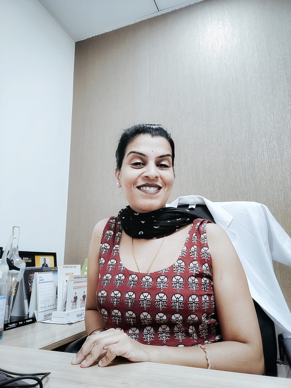 Dr. Shalini Rana conducting clinical orthopedic and nutritional consultation at desk